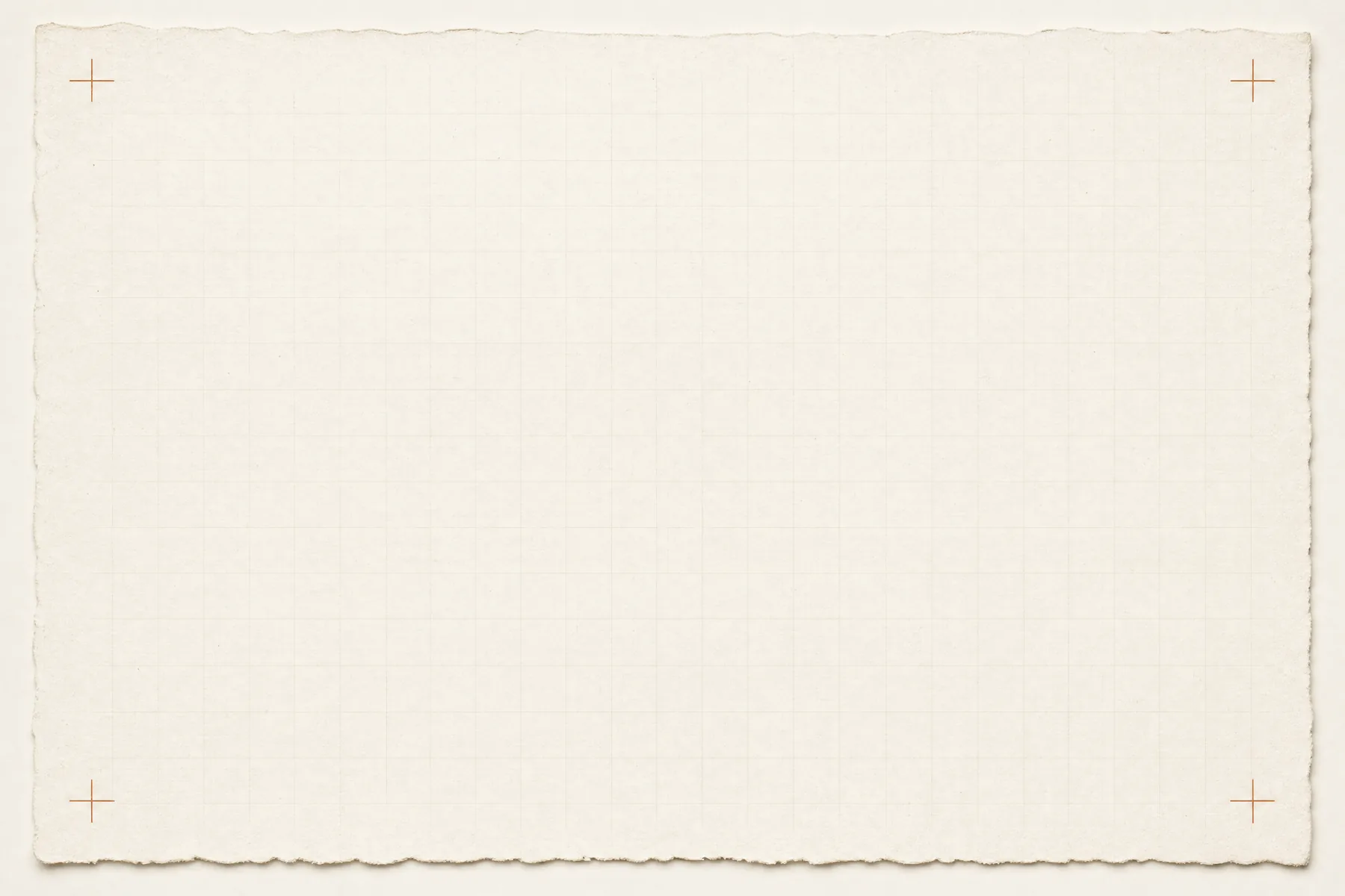 An empty piece of heavy cotton card stock lying flat with a faint pale grid and four small registration crosses at the corners.