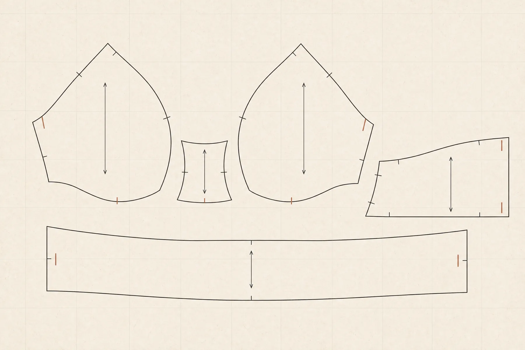 Loose paper pattern pieces for a bra arranged apart from one another: two cup panels, a bridge, a side wing and a band strip, each with notch marks and grainline arrows.